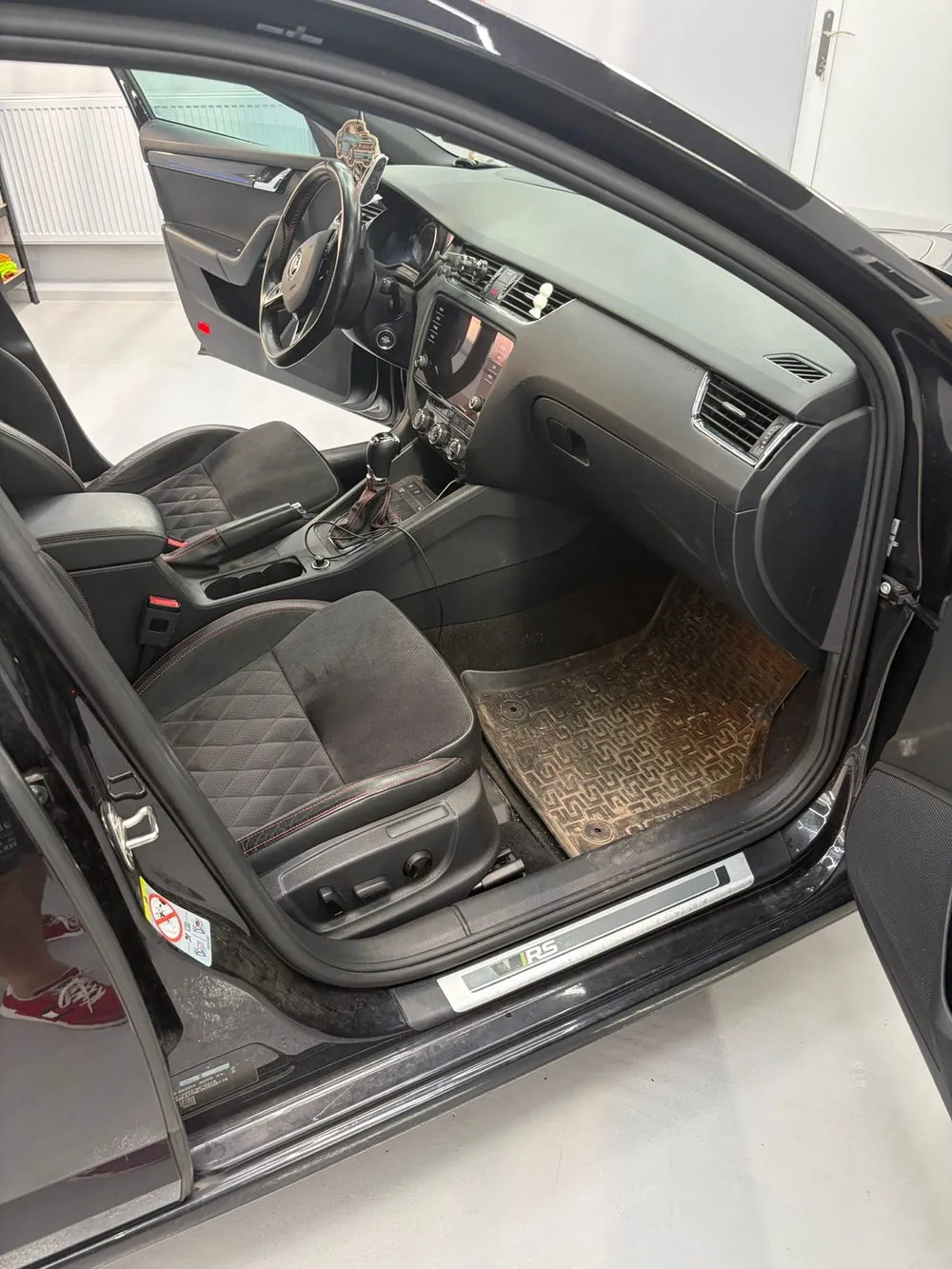 Interiér Škody Octavia RS po hĺbkovom čistení — čisté koberce, ošetrené plasty a kožené sedačky